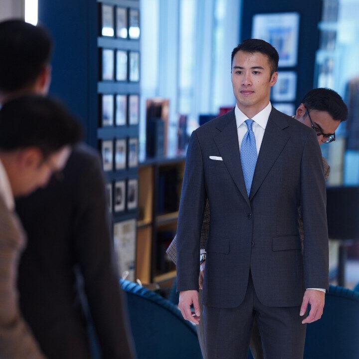 master tailor fitting a client at empire tailors