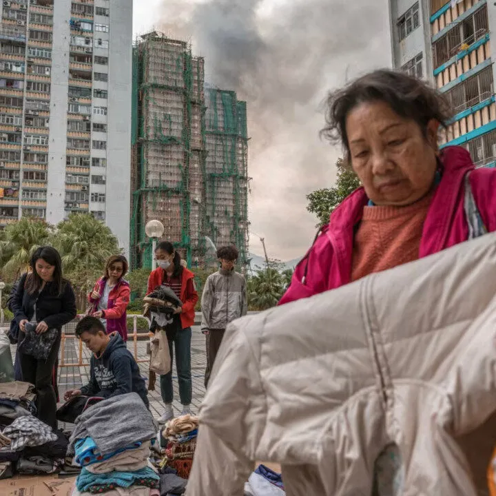 evacuees of wang fuk court going through supplies